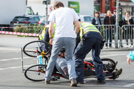 BERLIN - APRIL 03, 2016: The annual Berlin Half Marathon. Race through the city streets. Falling athletes of disabled in wheelchairs.のeditorial素材