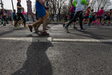 BERLIN - APRIL 03, 2016: The annual Berlin Half Marathon. Race through the city streets. Legs of athletes close-up.のeditorial素材