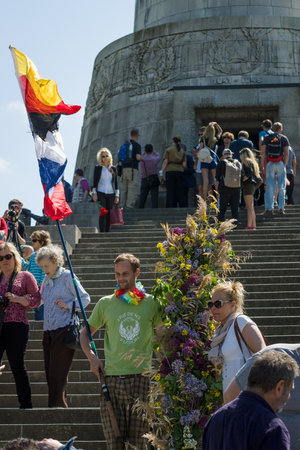 BERLIN - MAY 09, 2016: Victory Day in Treptower Park. Guests and visitors at the foot of the monument to the Liberator Soldier with Russian and German flags.のeditorial素材
