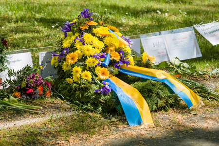 BERLIN - MAY 09, 2016: Victory Day in Treptower Park (Soviet war memorial). Crown of the Embassy of Ukraine lies in front of a mass grave of fallen soldiers.のeditorial素材