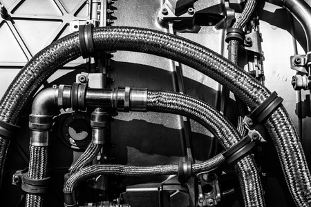 Fragment of modern technology. Details of engine pipelines. Black and white. Background.の写真素材