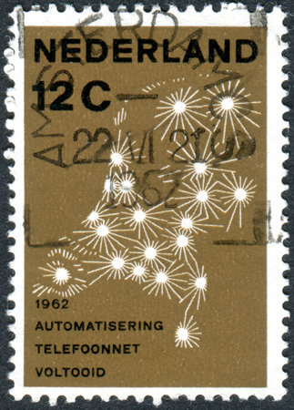 NETHERLANDS - CIRCA 1962: Postage stamp printed in the Netherlands, dedicated to the completion of the automation of the Netherlands telephone network, depicted map telephone network, circa 1962のeditorial素材