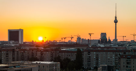 BERLIN - JUNE 22, 2013: Sunrise over Berlin. In the background the World Trade Center, buildings and cranes, Berlin TV Tower and hotel Park Inn by Radisson.のeditorial素材