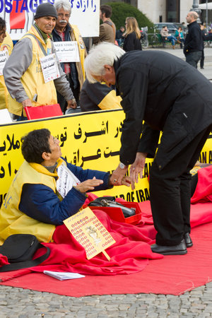 BERLIN, GERMANY - OCTOBER 25, 2013: The action (hunger strike) Iranian dissidents in front of the Brandenburg Gate in Berlin dedicated to the massacre in Camp Ashraf.のeditorial素材