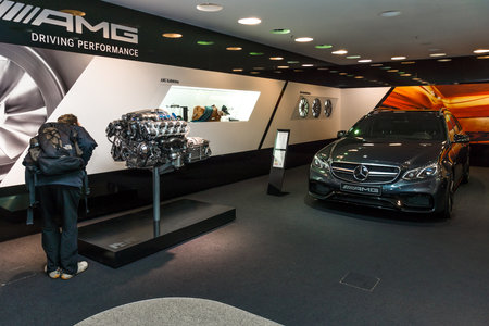 BERLIN - NOVEMBER 03, 2013: Showroom. Mid-size luxury car Mercedes-AMG E63 S4MATIC T-Modell and the engine AMG 63 M156 6.2 L V8. Produced since 2013.のeditorial素材