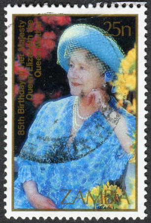 ZAMBIA - CIRCA 1985: A stamp printed in Zambia, is dedicated to the 85th anniversary of Queen Mother Elizabeth, shows a Portrait in blue, age 80, circa 1985のeditorial素材