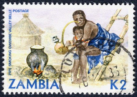 ZAMBIA - CIRCA 1981: A stamp printed in Zambia, is dedicated to Cultural Heritage, shows a Woman smoking pipe, circa 1981のeditorial素材
