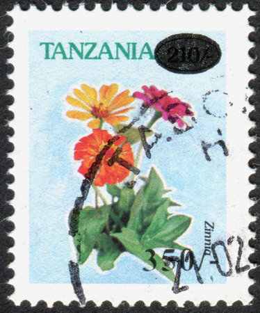 TANZANIA - CIRCA 1996: A stamp printed in Tanzania, shows a flower Zinnia, circa 1996のeditorial素材