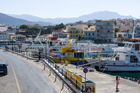 CRETE, GREECE - JULY 11, 2016: The embankment of a coastal elite tourist town on the Greek island of Crete - Agios Nikolaos.のeditorial素材