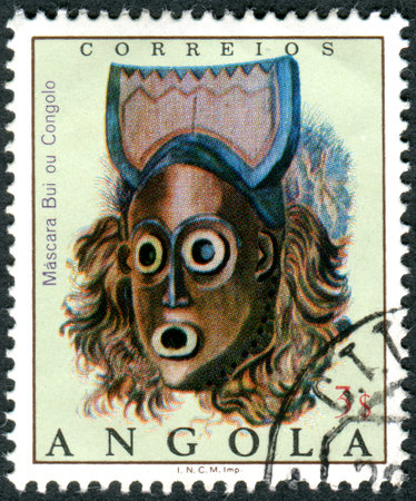 ANGOLA - CIRCA 1976: A stamp printed in Angola shows the Bui ou Congolo mask, circa 1976のeditorial素材
