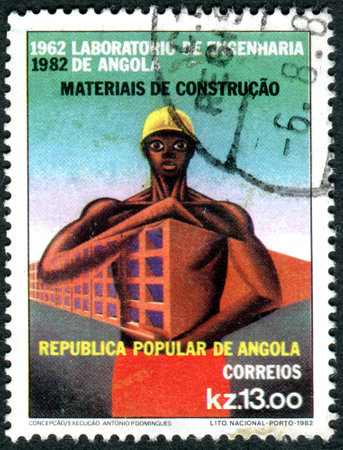 ANGOLA - CIRCA 1982: A stamp printed in Angola, dedicated to 20th Anniversary of the Engineering Laboratory of Angola, shows a construction worker, circa 1982のeditorial素材