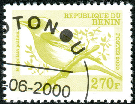 BENIN - CIRCA 2000: A stamp printed in Benin, shows a bird Eastern Olivaceus Warbler (Hippolais pallida), circa 2000のeditorial素材