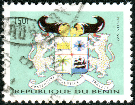 BENIN - CIRCA 1997: A stamp printed in Benin, shows the National Coat of Arms, circa 1997のeditorial素材