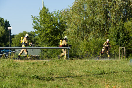 BERLIN - JULY 21, 2013: The fire of construction trailer. District of Marzahn-Hellersdorf. The arrival of fire truck. Fire brigade at work.のeditorial素材