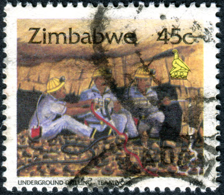 ZIMBABWE - CIRCA 1996: A stamp printed in Zimbabwe, shows the Underground Drilling - Teamwork, circa 1996のeditorial素材