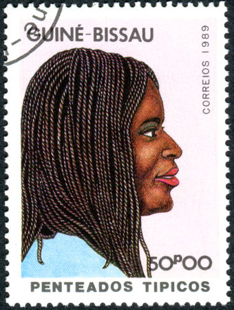 GUINEA - BISSAU - CIRCA 1989: A stamp printed in Guinea-Bissau, dedicated to International Women's Day, show a Traditional hairstyle, circa 1989のeditorial素材
