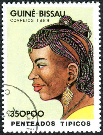 GUINEA - BISSAU - CIRCA 1989: A stamp printed in Guinea-Bissau, dedicated to International Women's Day, show a Traditional hairstyle, circa 1989のeditorial素材