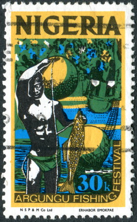 NIGERIA - CIRCA 1973: A stamp printed in Nigeria, shows a Argungu Fishing Festival, circa 1973のeditorial素材