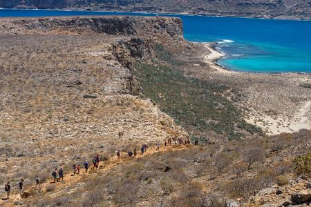 The descent of tourists from the ancient Venetian fortress. Natural landscape of the island Imeri Gramvousa. Mediterranean Sea. Crete. Greece.の写真素材