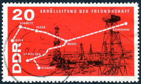 GERMANY - CIRCA 1966: A stamp printed in Germany (GDR), shows Map of Oil Pipeline and Oil Field, circa 1966のeditorial素材