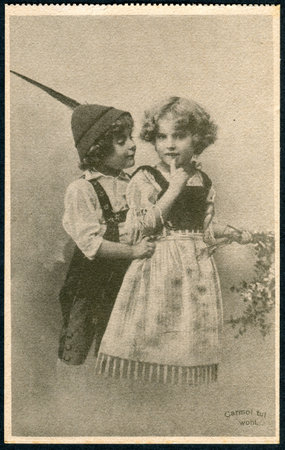GERMANY - CIRCA 1914: A promotional postcard (Carmol tut wohl) printed in Germany, shows a boy and a girl in traditional Bavarian dress, circa 1914のeditorial素材