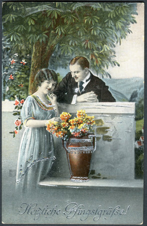 GERMANY - CIRCA 1919: A postcard printed in Germany, shows a couple in love. The inscription in...