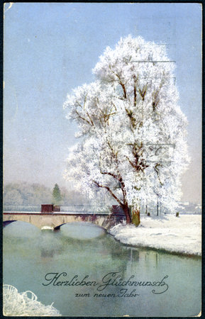 SWITZERLAND - CIRCA 1920: A Christamas postcard printed in Switzerland shows a winter landscape. The inscription in German: Happiness in the New Year, circa 1920のeditorial素材