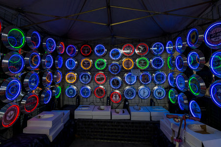 STUTTGART, GERMANY - MARCH 03, 2017: Background of various neon wall clocks with automotive themes....