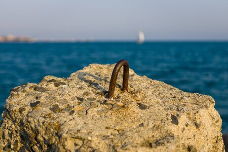 Rusty fasteners on a concrete block.の写真素材
