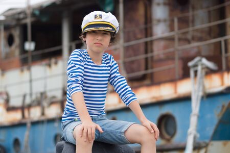 Portrait of a boy in a vest (Telnyashka) and captain's cap.の写真素材
