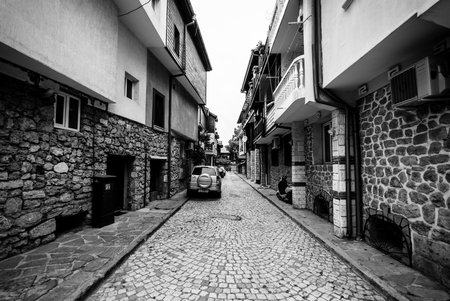 NESEBAR, BULGARIA - AUGUST 21, 2017: Typical houses and narrow streets in the  town of Nesebar. Black and white. Nesebar is an ancient city and one of the major seaside resorts on the Bulgarian Black Sea Coast.のeditorial素材