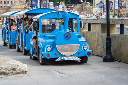 NESEBAR, BULGARIA - AUGUST 21, 2017: Stylized for the locomotive with the carriages, a walking road train. Nesebar is an ancient city and one of the major seaside resorts on the Bulgarian Black Sea Coast.のeditorial素材