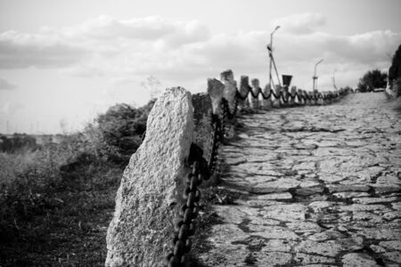 The old stone road leaving into the distance. Black and white.の写真素材