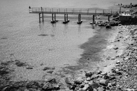 Stone coast of the ancient seaside town of Sozopol. Bulgaria. Black and white.の写真素材