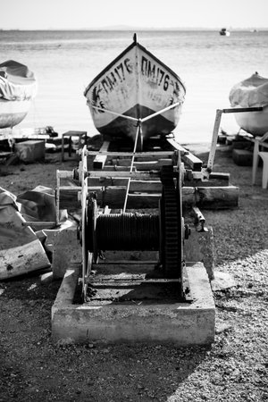 POMORIE, BULGARIA - AUGUST 26, 2017: Fishermen's boats stand on the shore of the seaport of the seaside resort town of Pomorie. B;lack and white.のeditorial素材