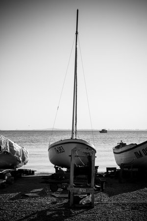 POMORIE, BULGARIA - AUGUST 26, 2017: Fishermen's boats stand on the shore of the seaport of the seaside resort town of Pomorie. Stylization. Vignetting. Black and white.のeditorial素材