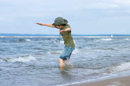 The guy is happy on the sandy beach of the sea.の写真素材