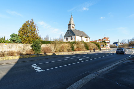 NEUSTADT (HESSE), GERMANY - FEBRUARY 18, 2018: Typical architecture and buildings in the old town. Church and territory of the city cemetery.のeditorial素材