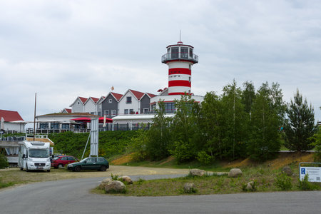 GEIERSWALDE, GERMANY - MAY 20, 2017: The hotel building and restaurant are stylized under the lighthouse on the artificial lake Geierswalder See. Free State of Saxony.のeditorial素材