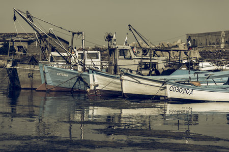 SOZOPOL, BULGARIA - AUGUST 24, 2017: Fishing boats at the seaport are at the pier. Vintage toning, stylization.のeditorial素材