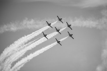 BERLIN, GERMANY - APRIL 28, 2018: Demonstration flight by the aerobatic team Patrulla Aguila (Eagle Patrol). Black and white. Exhibition ILA Berlin Air Show 2018.のeditorial素材