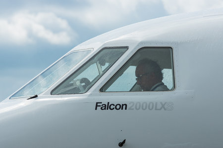 BERLIN - APRIL 26, 2018: Pilot in the cockpit of business jet Dassault Falcon 2000LXS. Exhibition ILA Berlin Air Show 2018のeditorial素材