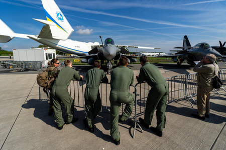 BERLIN, GERMANY - APRIL 27, 2018: Multirole fighter Dassault Rafale C on the airfield and a group of...