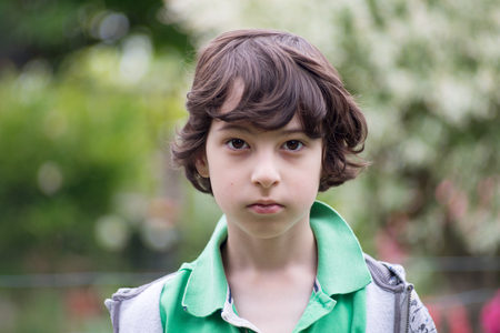 Portrait of a boy in casual clothes on a nature background.の写真素材