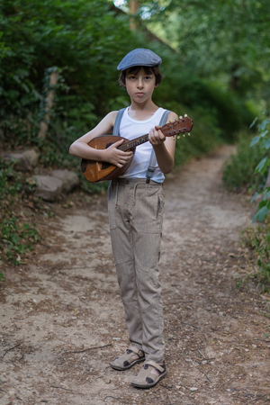 Portrait of a boy with a mandolin.