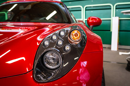 PAAREN IM GLIEN, GERMANY - MAY 19, 2018: Headlamp of the sports car Alfa Romeo 4C Spider (Type 960). Close-up. Die Oldtimer Show 2018.のeditorial素材