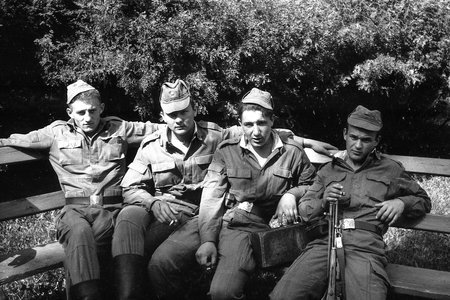 MOSCOW REGION, RUSSIA - CIRCA 1992: Soldiers of the Russian army are sitting on a wooden bench. Film scan. Large grain.のeditorial素材