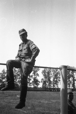MOSCOW REGION, RUSSIA - CIRCA 1992: A soldier of the Russian army on a sports horizontal bar. Film scan. Large grain.のeditorial素材