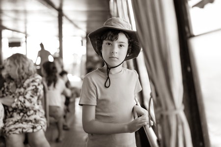 Portrait of a boy on the deck of a pleasure ship. Sepia. Stylization.の写真素材