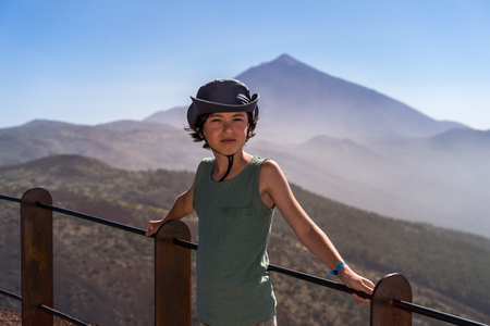 Portrait of a boy in a hat and t-shirt against the background of the volcano Teide. Tenerife. Canary Islands. Spain.の写真素材